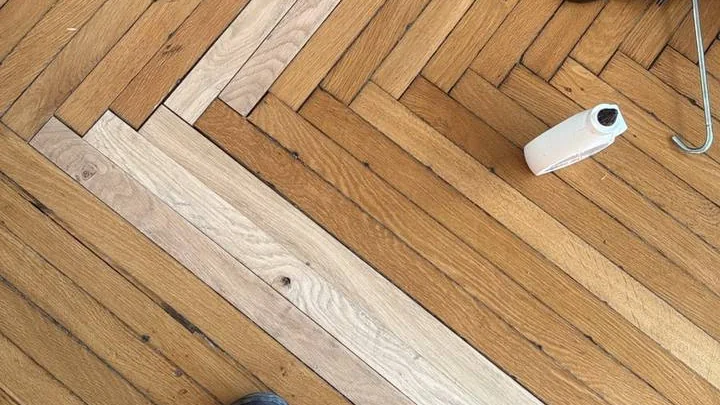 Remplacement de lames abîmées dans un parquet ancien, en cours de rénovation — Les Ponceurs Réunis