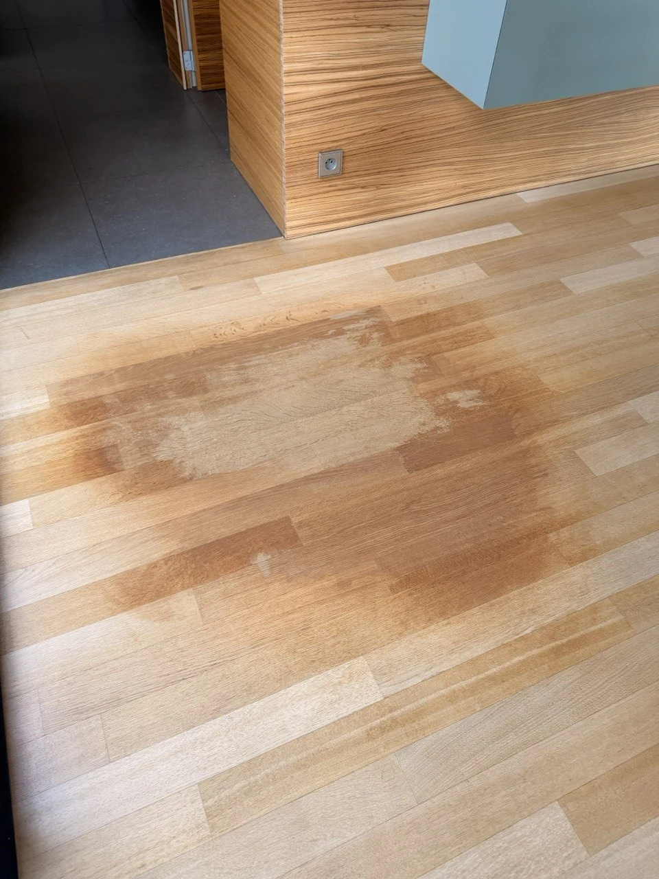 Parquet en bois avec une tache de dégât des eaux au centre